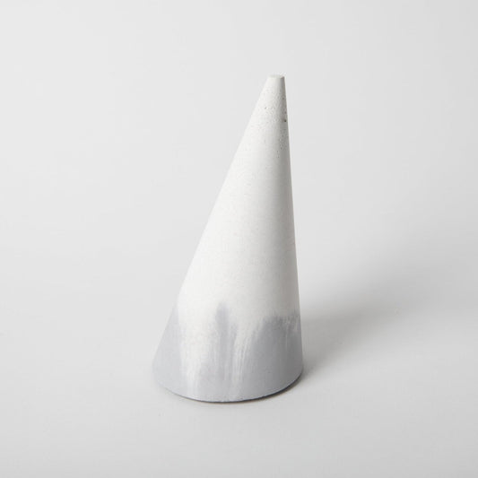 Cone shaped concrete bangle holder with cork base in grey and white.
